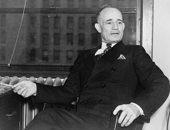 Black an White Photo of Napoleon Hill sitting in chair.