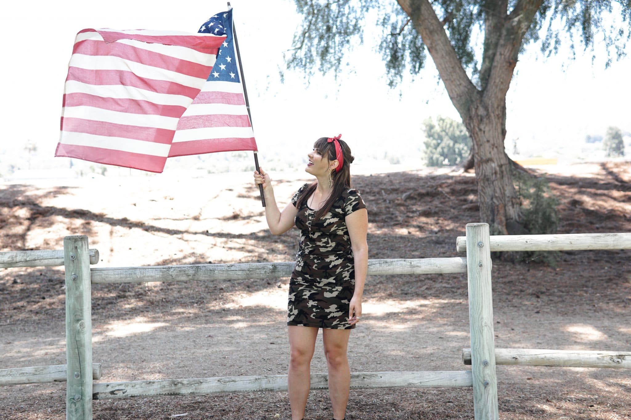 Woman waving a U.S. flag to represent the diversity and freedom in America