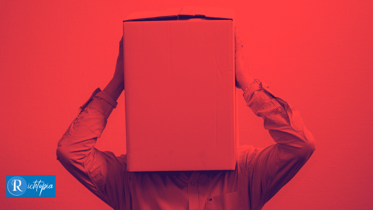 Photo of a man with his head inside a box