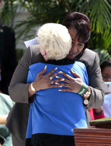 Bernice King hugging Peggy Wallace-Kennedy.
