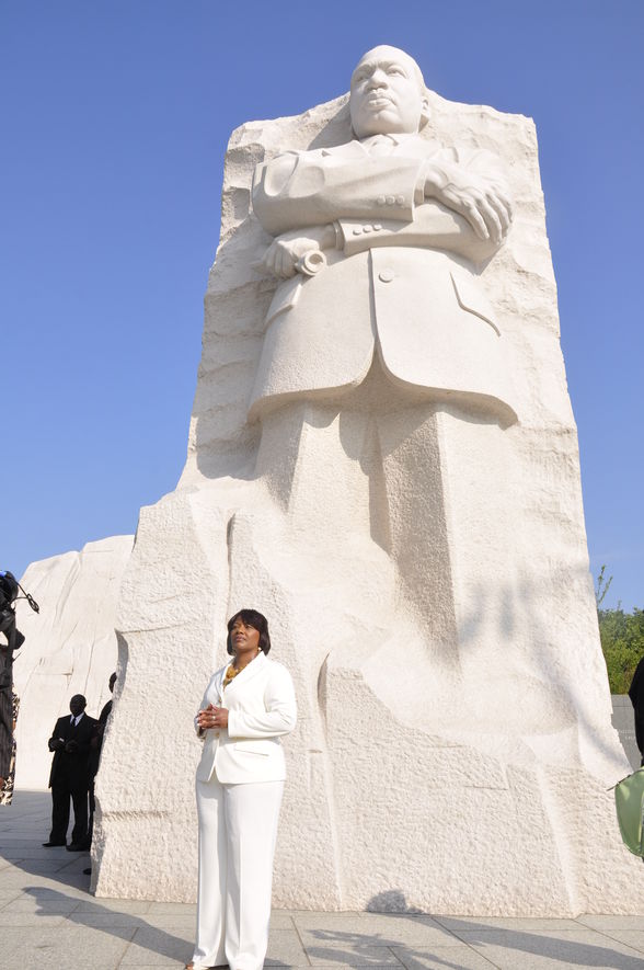 Photo of Bernice King standing in front of her dad's (Martin Luther King J.R.'s monument)