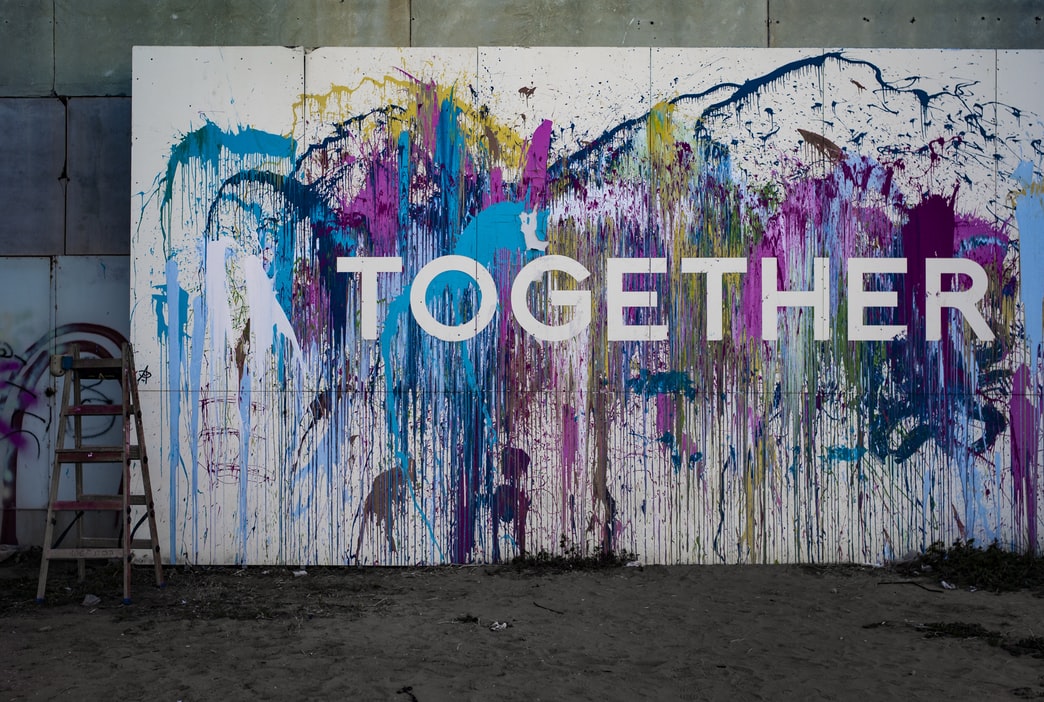 Splattered painting which writes 'Together'.
