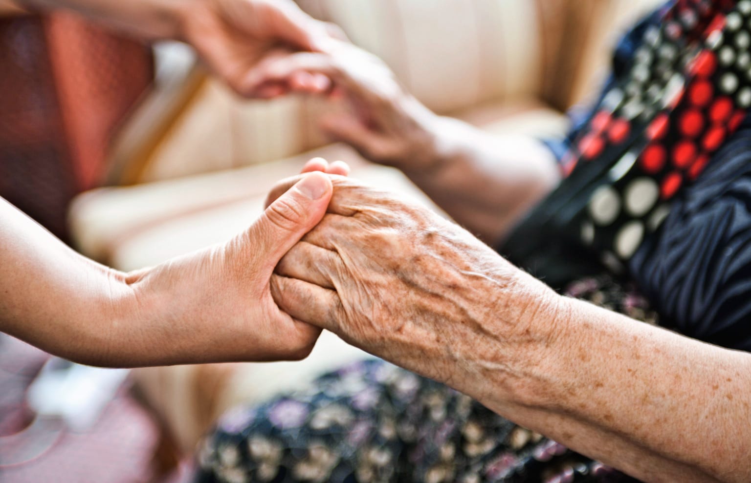 Photo of a woman acting as a company representative and supporting an elderly lady as part of a Corporate Social Responsibility (CSR) programme.