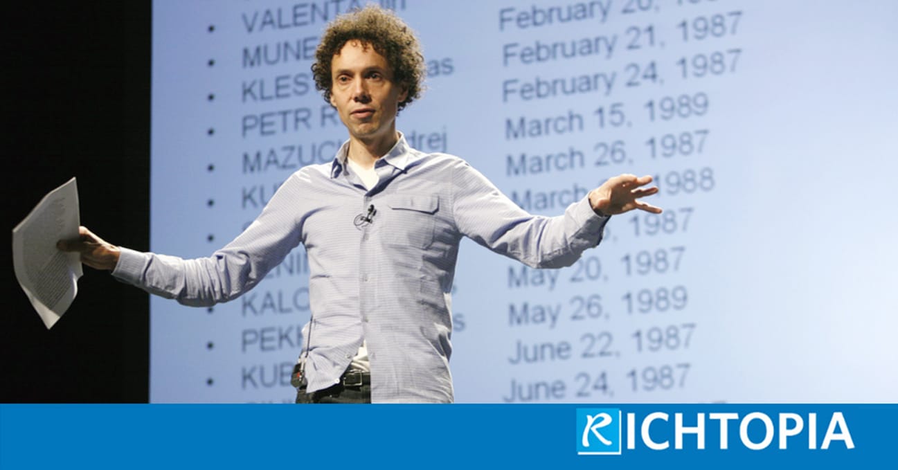Photo of Malcom Gladwell wearing a shirt and jeans, talking at a seminar room about his notions on leadership.