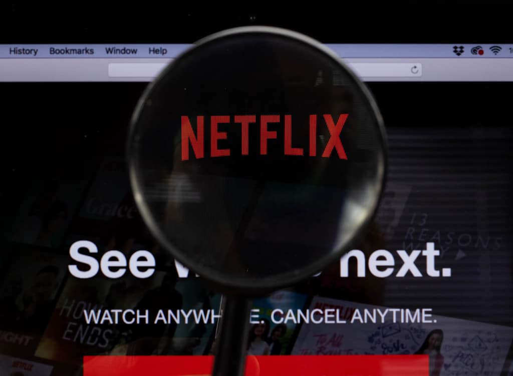 Photo of magnifying glass looking into Netflix logo