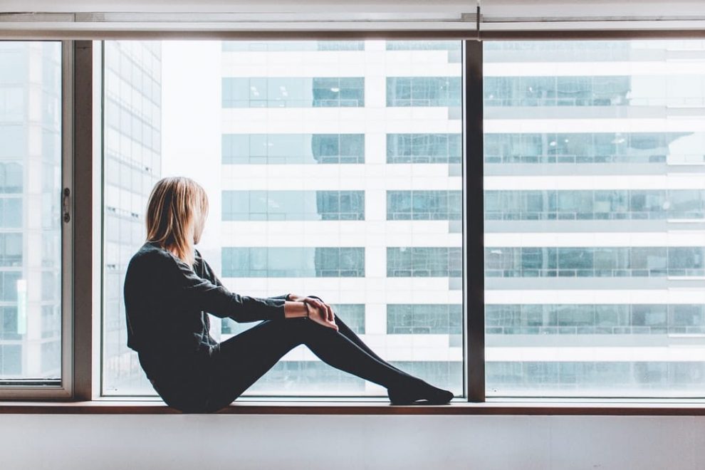 Woman looking out of office window