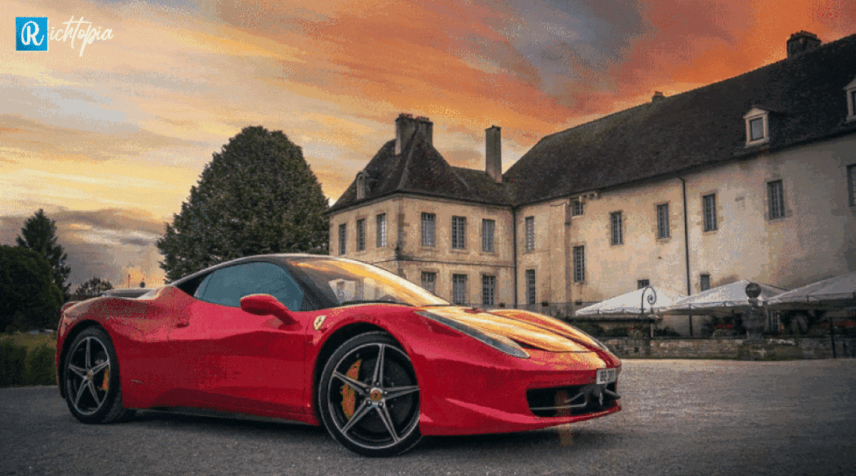 Red Ferrari parked outside a mansion in the UK during sunset
