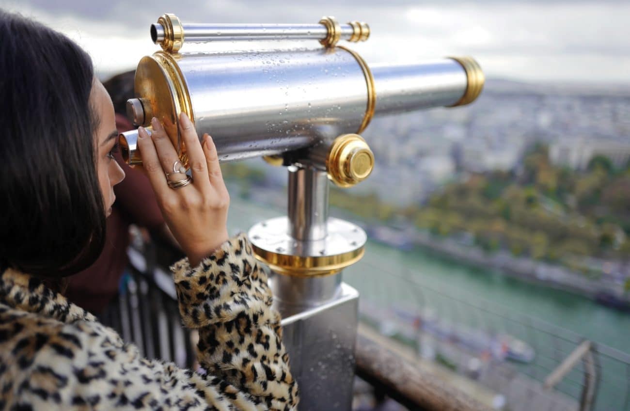 Woman looking through a telescope