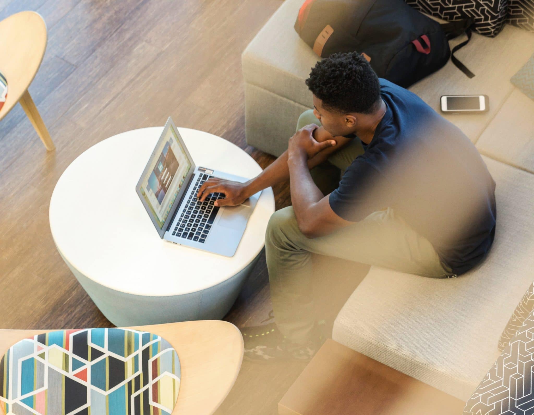 Photo of a young man signing into LinkedIn on his laptop.