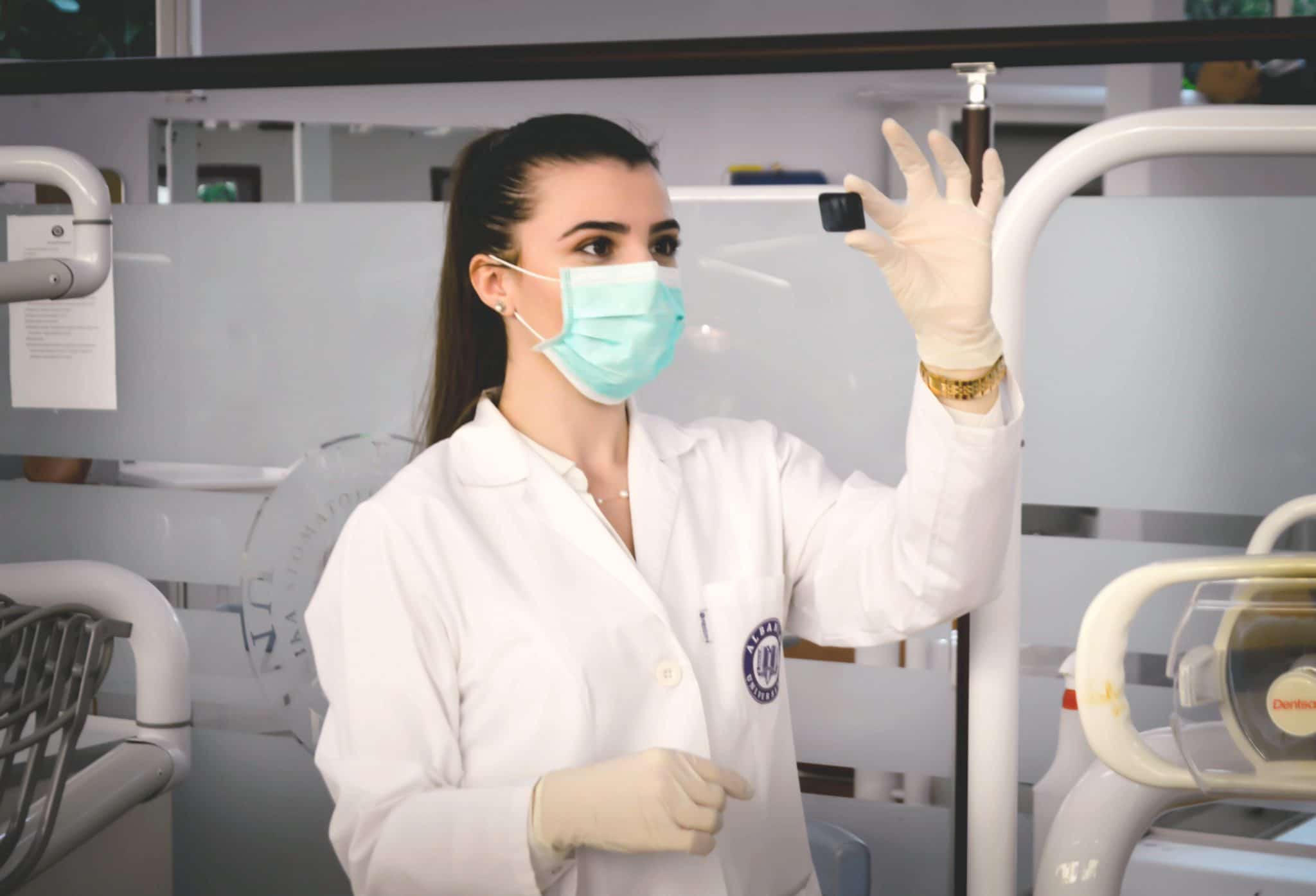 Woman scientist holding a piece of test wearing latex gloves in a laboratory
