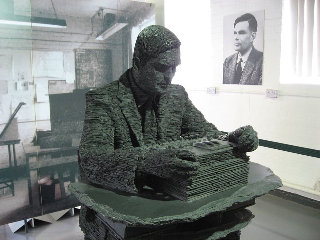 The 1.5 -ton statue of Alan Turing, by Stephen Kettle commissioned by the American billionaire Sidney Frank. This statue at Bletchley Park is made of about half a million pieces of slate quarried in Wales. People who knew him say this takes their breath away. Unfortunately, you can't see his coffee cup under his desk.