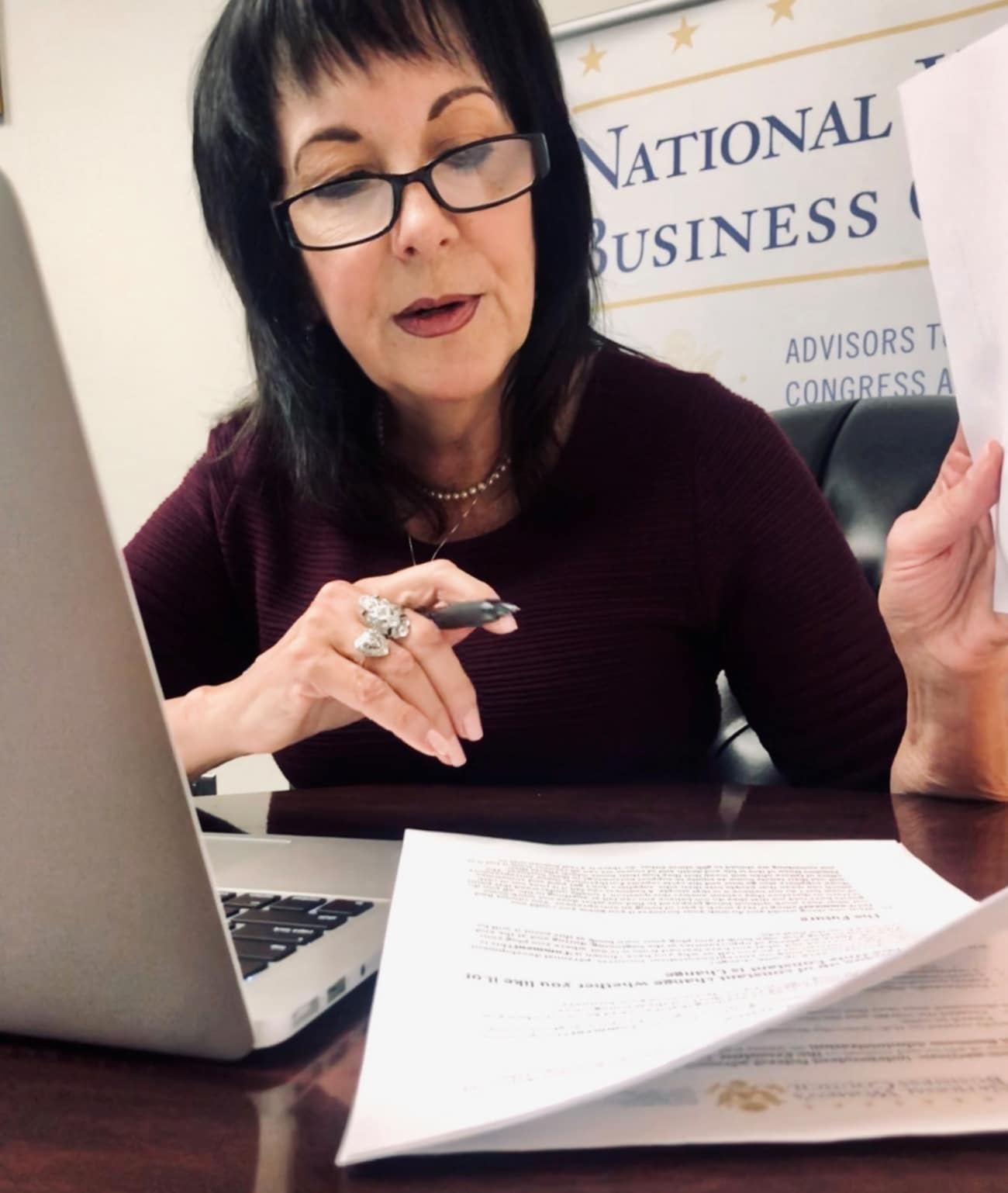 Photo of Liz Sara working in her office at the National Women's Business Council
