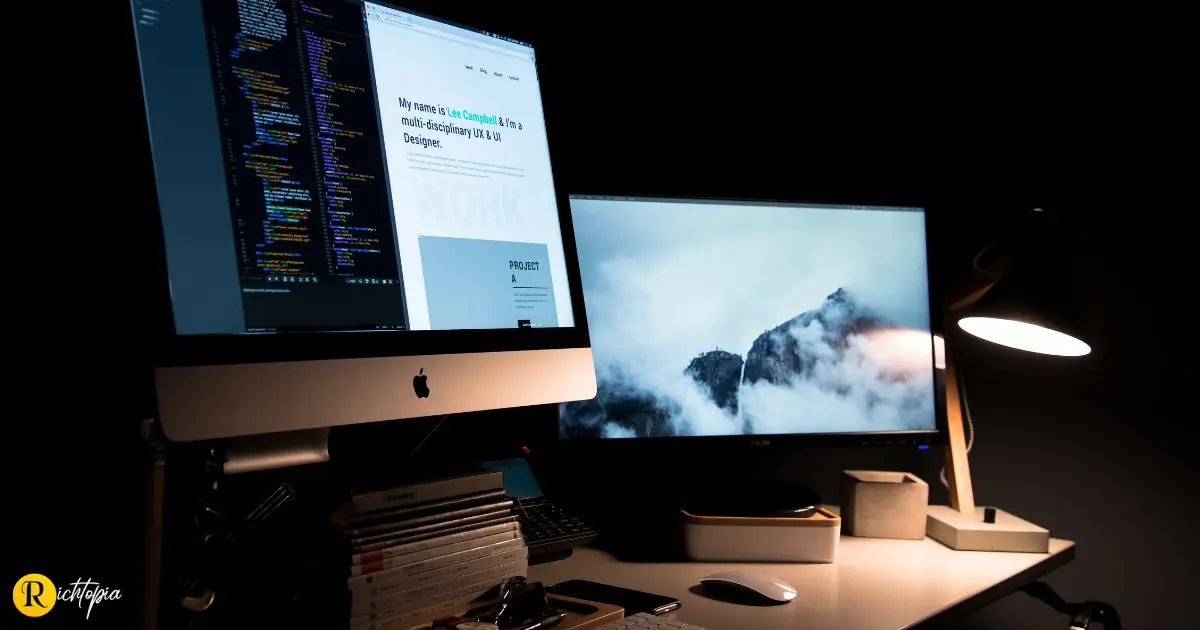 Photo of two Apple computers being used for web design