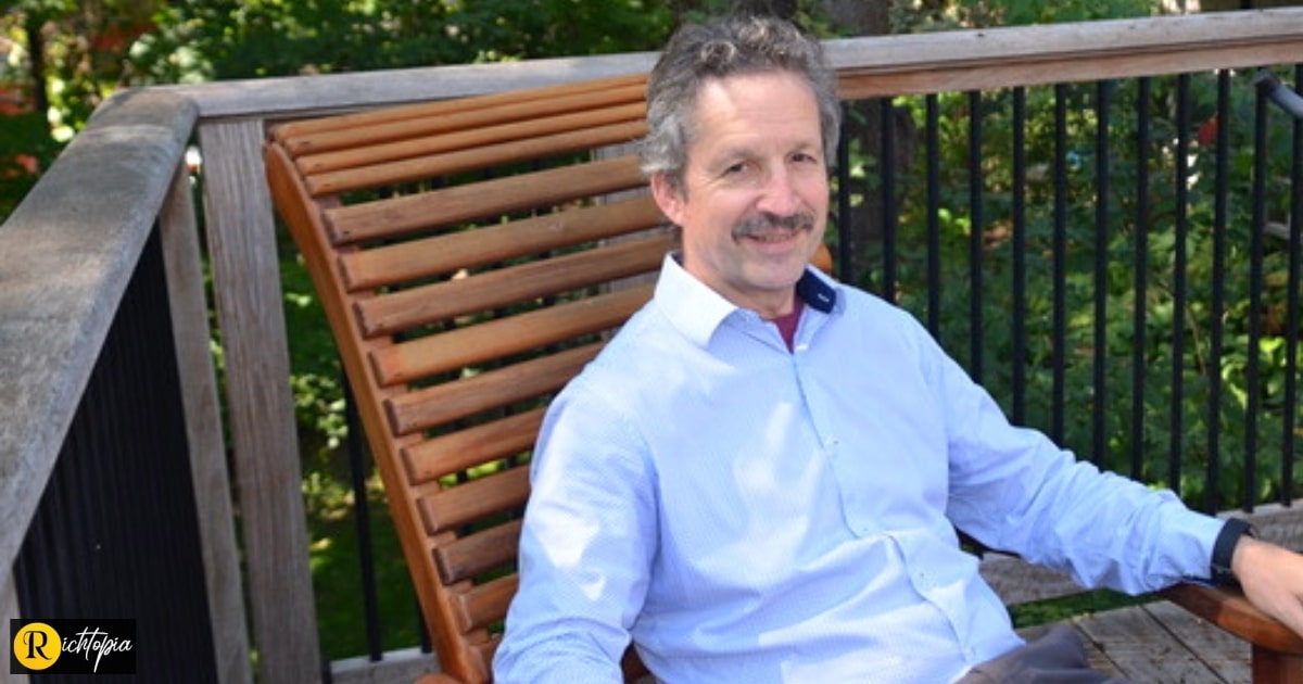 Photo of Jim Estill wearing a blue shirt and sitting in a chair in his garden. Original photo for Richtopia and National Mentoring Day.