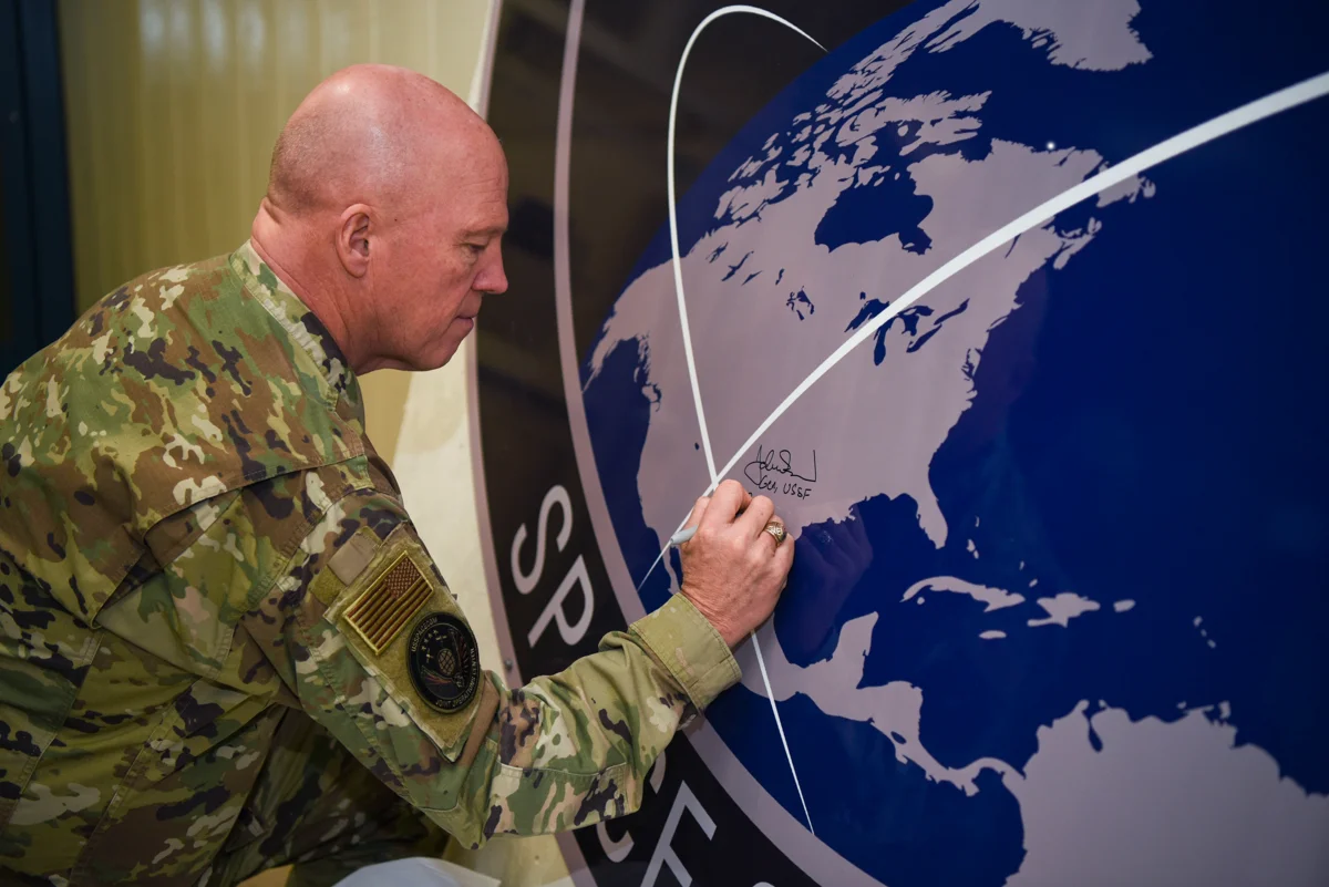 General John Raymond, U.S. Space Force chief of space operations, signs the United States Space Command sign inside of the Perimeter Acquisition Radar building Jan. 10, 2020, on Cavalier Air Force Station, North Dakota. Raymond toured inside the PAR building, where he learned first-hand how operations work inside the facility and listened to Airmen’s suggestions. (U.S. Air Force photo by Senior Airman Melody Howley).