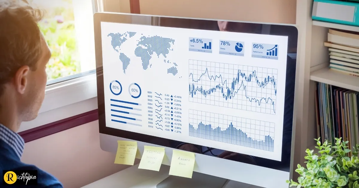 Photo of a man looking at big data on his desktop iMac computer.